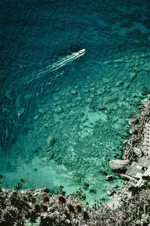 a boat sails through the ocean blue water