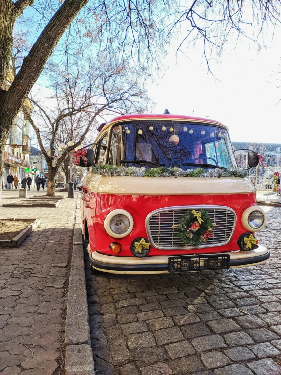 the front end of a vintage bus decorated with flowers