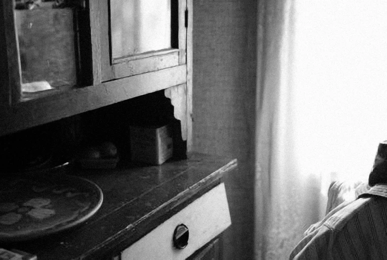 the interior of a bathroom with a toilet, sink, and cabinet