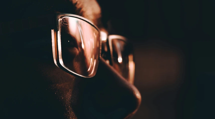 a pair of glasses are reflected in the mirror