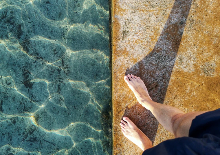 the bottom view of someone's feet in the water