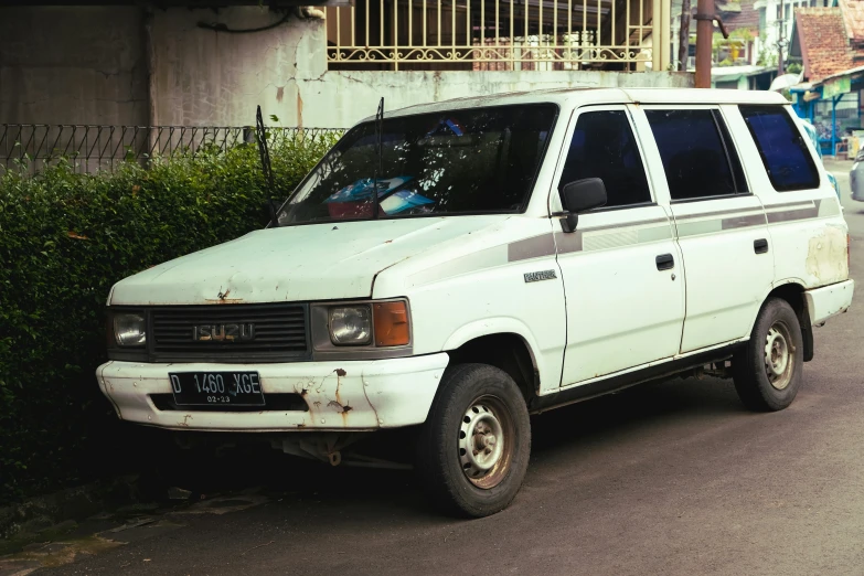 this is an old white station wagon in front of a wall