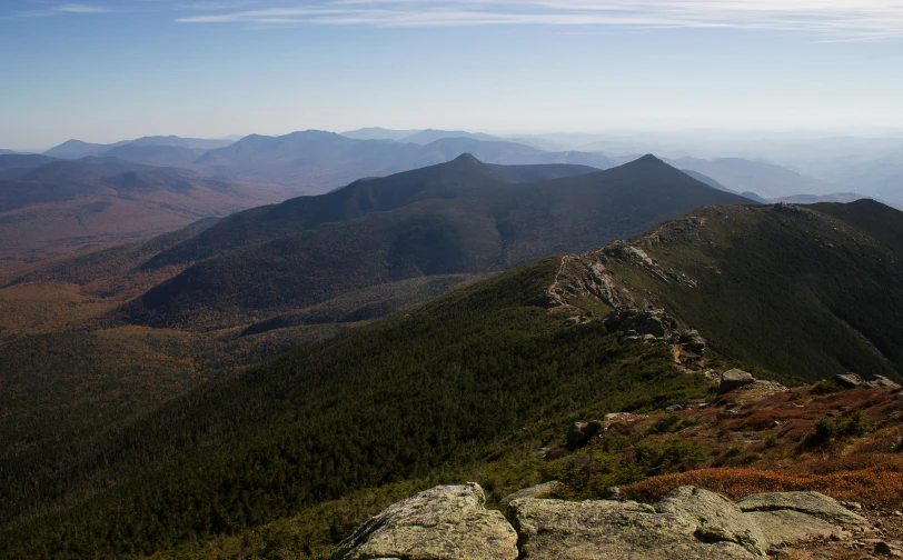 the view from atop of a mountain shows large peaks