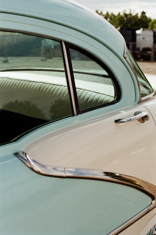 a car door handle on a vintage blue car