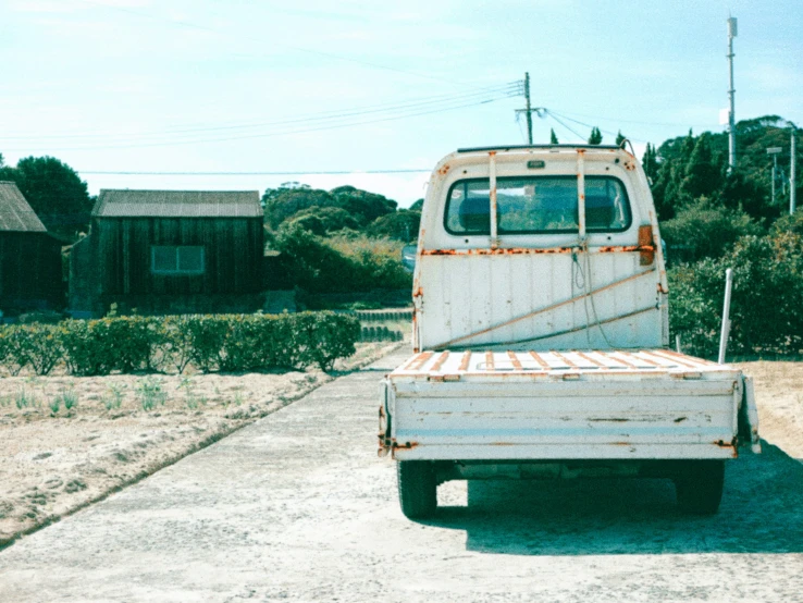 an old truck is parked near the houses