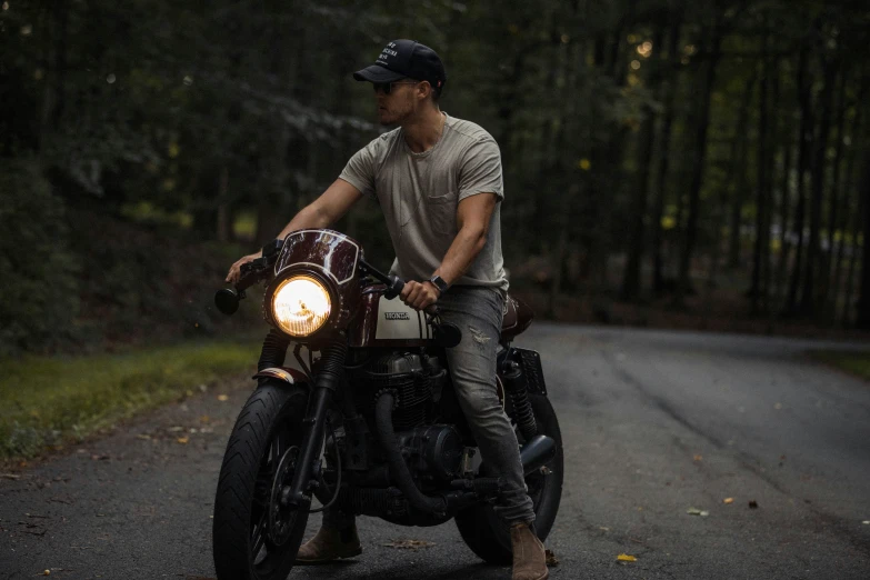 a man riding on the back of a motorcycle down a street