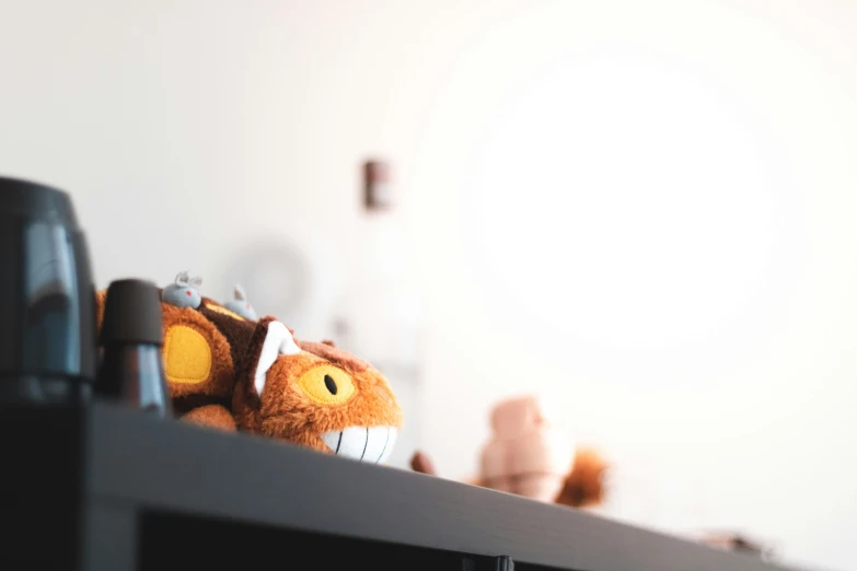a stuffed animal on top of some microwaves