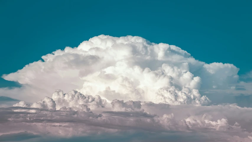 a very big white cloud with lots of clouds in the background