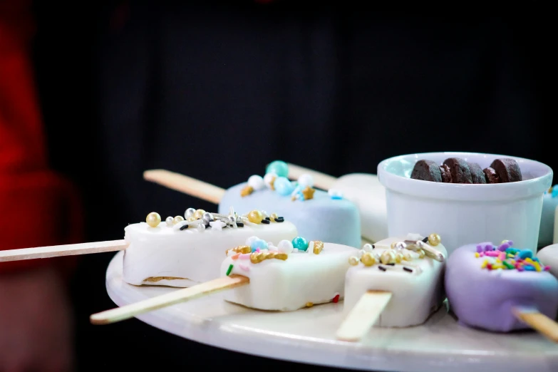 a tray with pieces of marshmallow topped with sprinkles