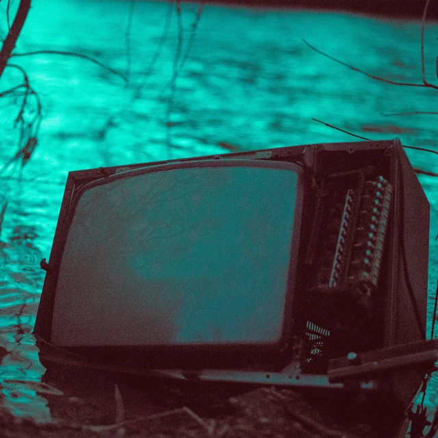 an old tv set sitting in the water