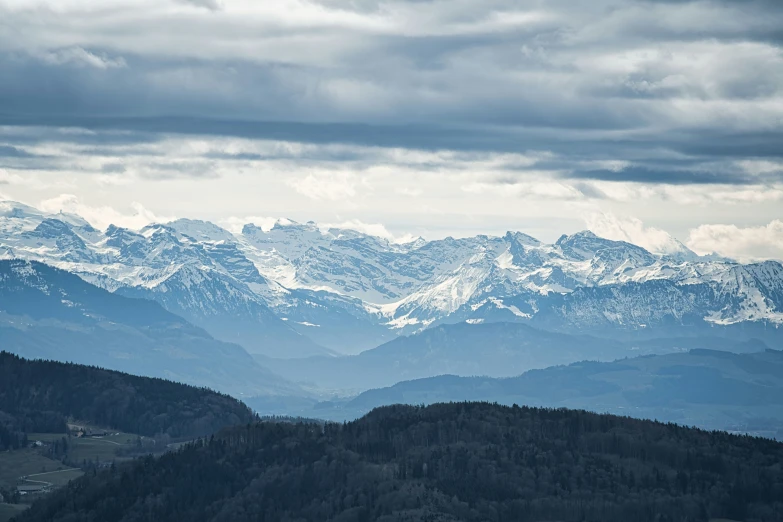 a po taken from the top of a mountain with snow - capped mountains