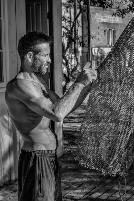 man with beard in black and white holding mesh