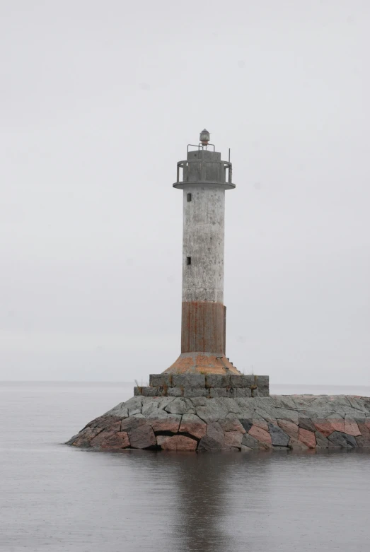 there is a lighthouse that looks out over the water