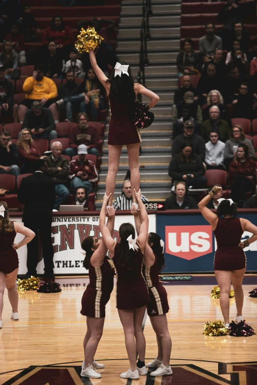 a group of cheerleaders are performing at a basketball game