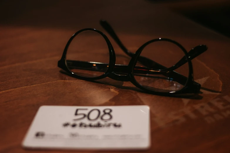 a pair of glasses and a price tag on top of a table