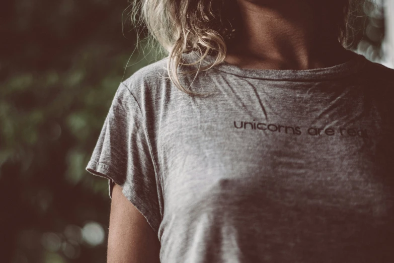 a close up of a person wearing a shirt with the word unicorns on it