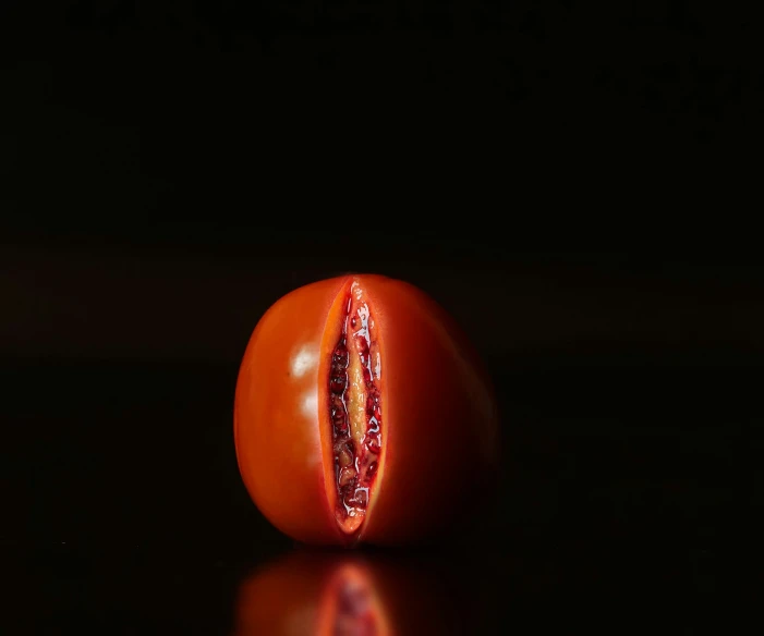 a half eaten, whole tomato still attached to the stem
