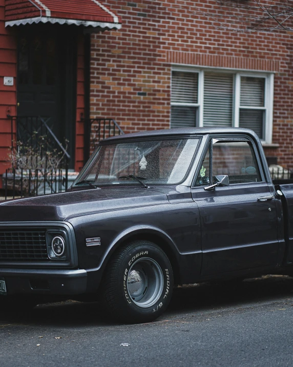 an old truck parked in front of a building