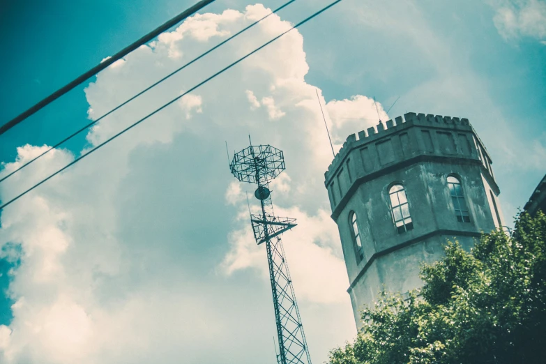 a view of a building from a ground level looking up at a tower