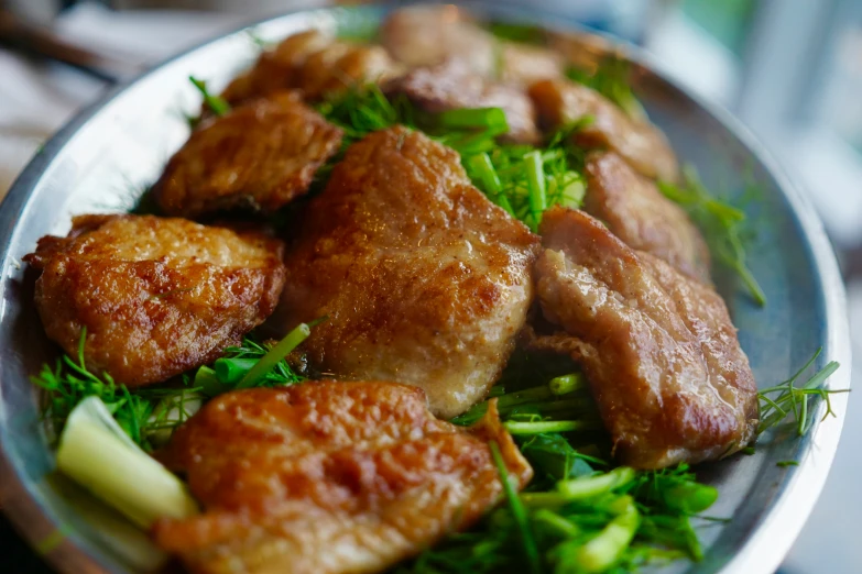 a close up of chicken with broccoli and onions