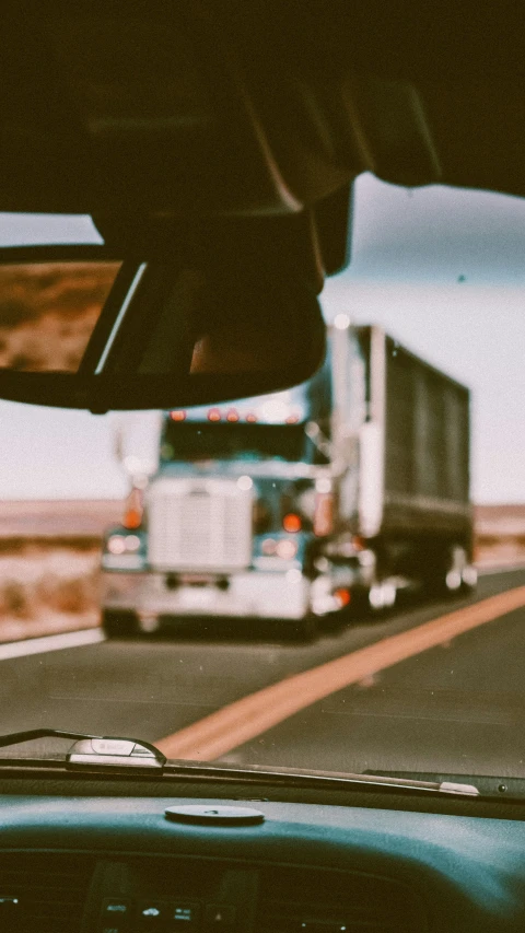 a semi truck is approaching a truck on the road