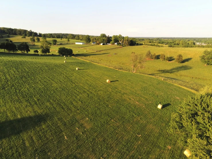 an overhead view of many large fields and a few bales