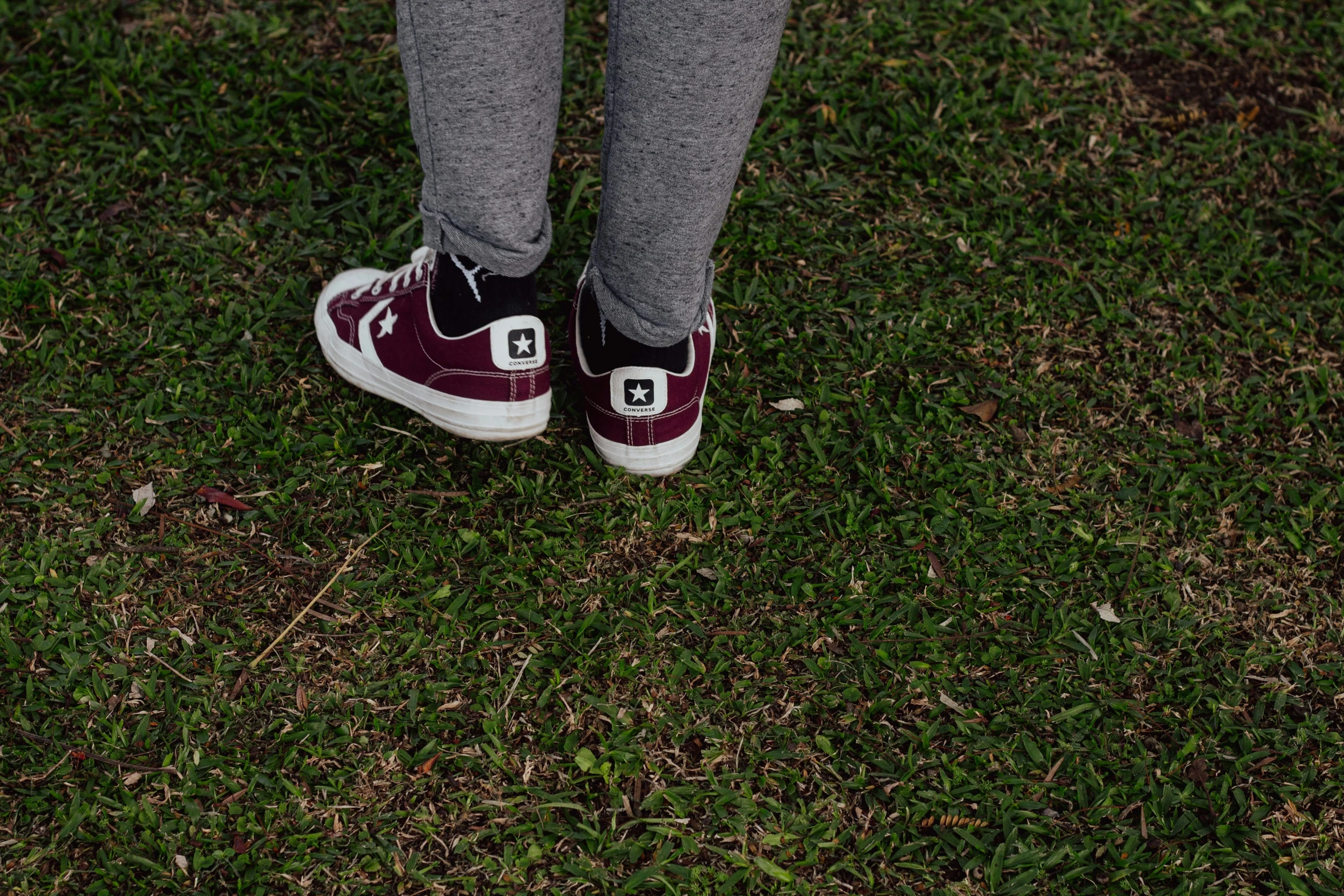 a person standing on top of a field wearing shoes