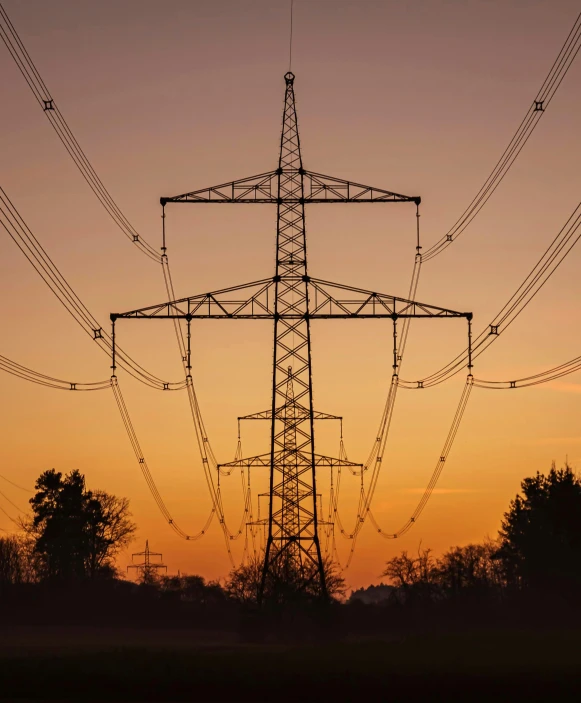 an electric pole with several wires at dusk