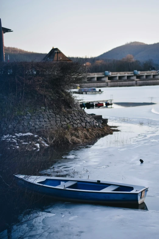 a small boat is sitting in the middle of the icy water