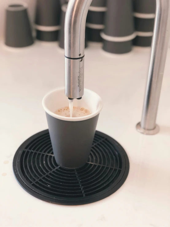 a coffee cup sitting on top of a white counter