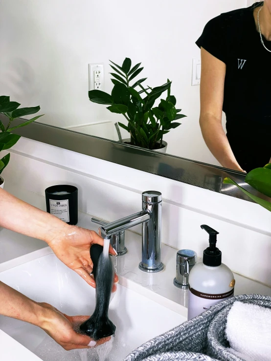 woman using shower brush to clean and shave her hands