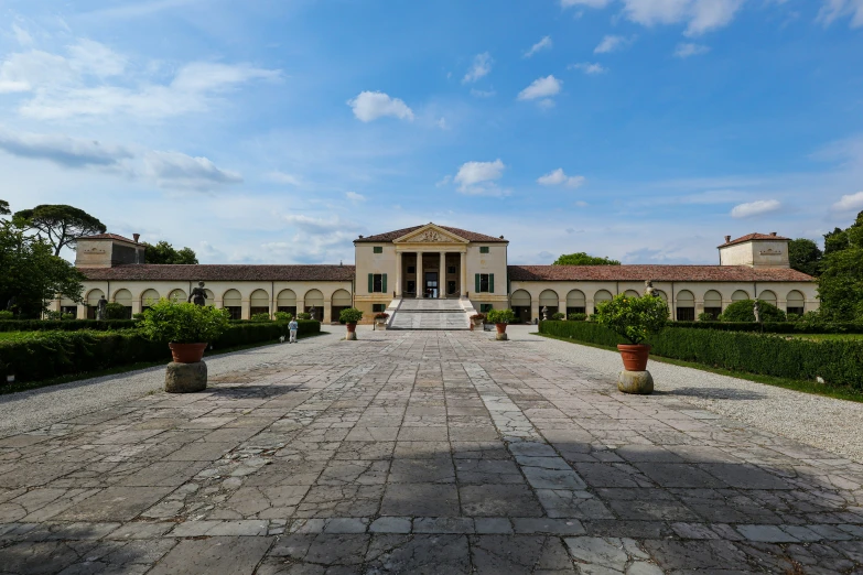 an exterior s of a large house with columns and steps