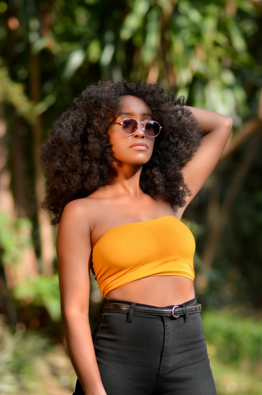 a women with dark skin wearing an orange top