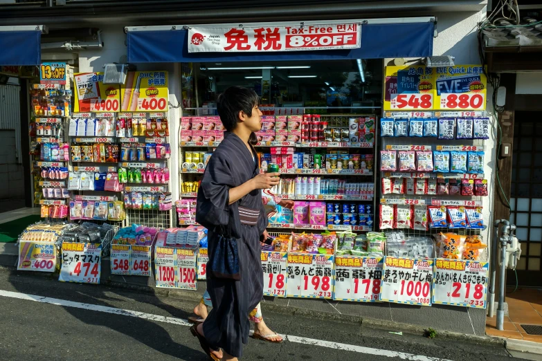 an asian man is walking past a convenience store