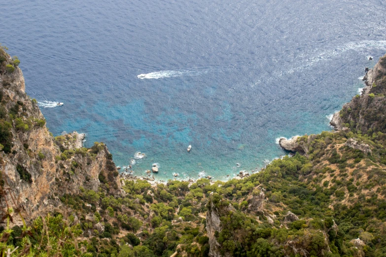 the view from a high angle of a lake next to a forested area