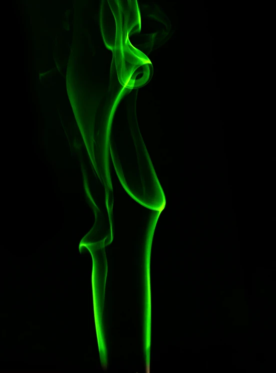 smoke coming out of a cigarette in the dark