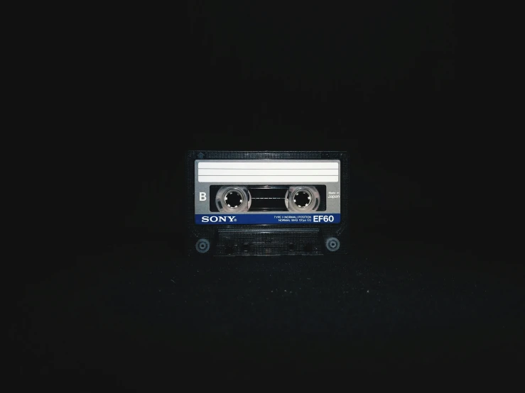 a cassette is sitting on top of a black surface