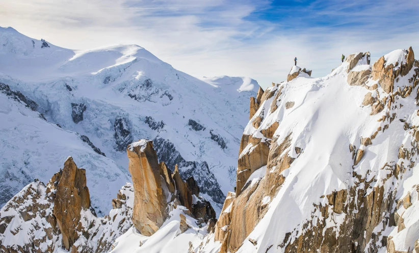 the snowy mountains are covered with large rocks