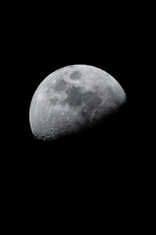 a quarter of the moon in the dark sky