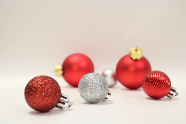 shiny red ornaments are grouped together in a line