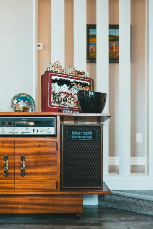 a stereo and tray sitting on top of a wood cabinet