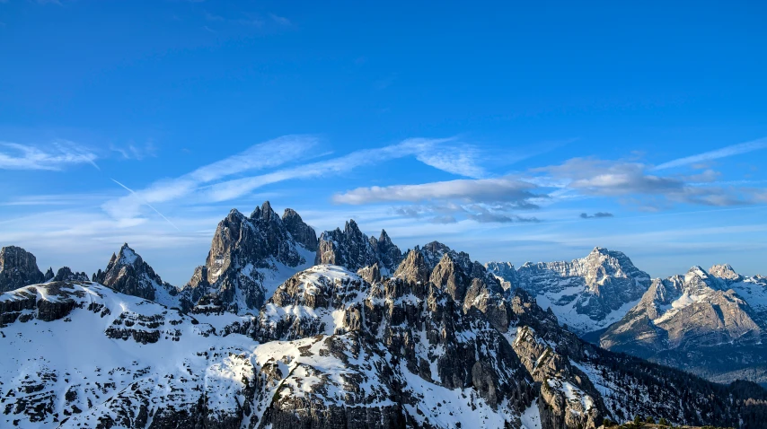 a snowy mountain with mountains in the background