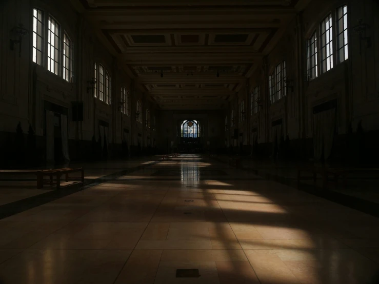 the sun shines through the windows on the floor of an empty hall