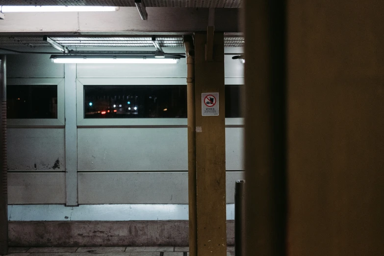 a hallway with lights at night and a sign out front