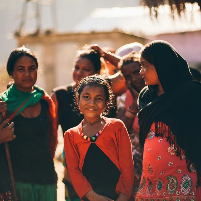 a girl stands in front of a group of people