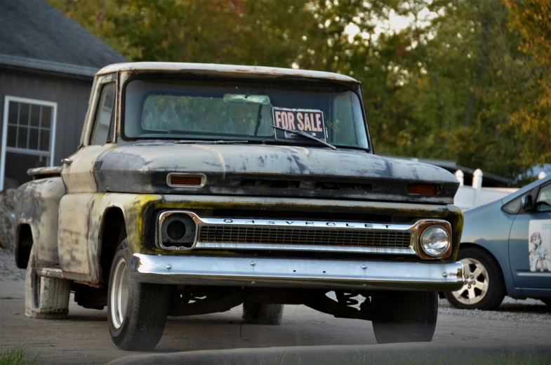 an older pickup truck with a for sale sign in the middle of the front windshield