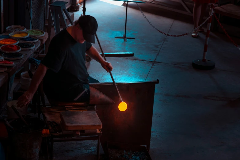 a person is blowing the colors of lights into a vase