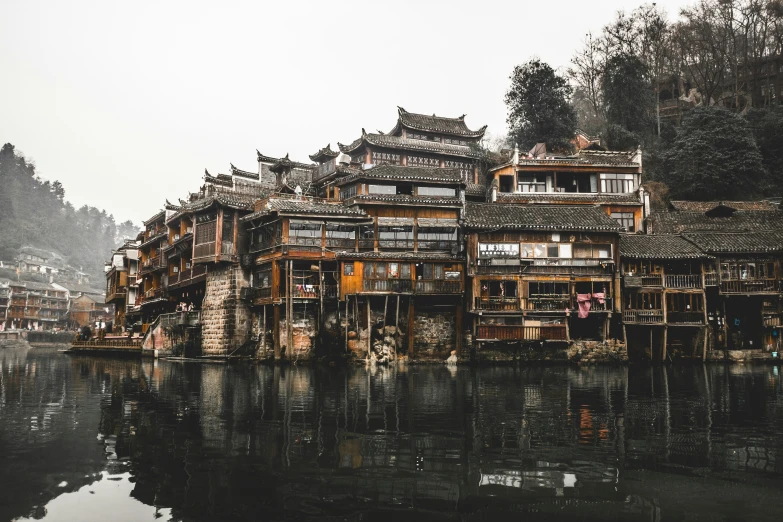 the building is next to the river that has many windows