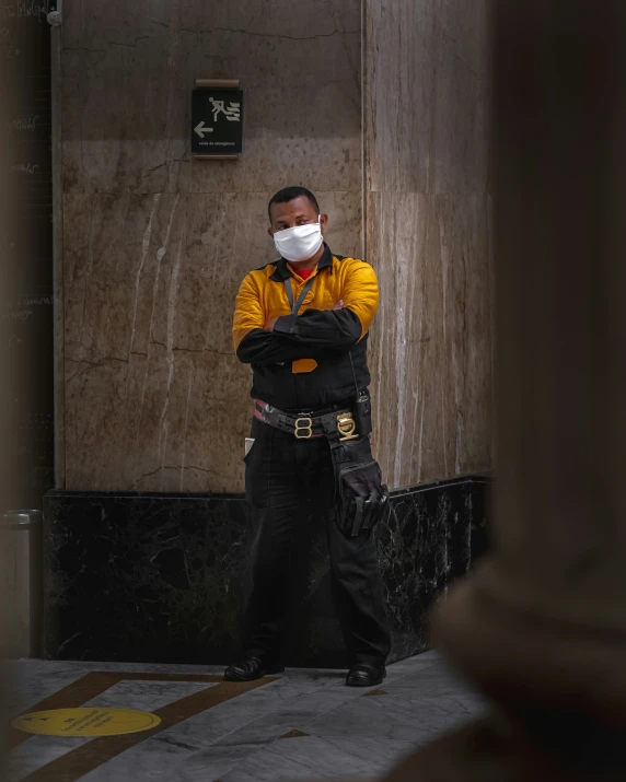 a man in yellow shirt wearing a mask