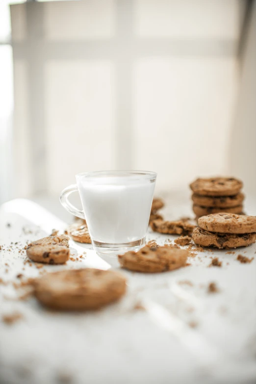 the cookie is next to a glass of milk